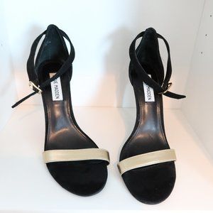 black strap heel with gold strap across the top.